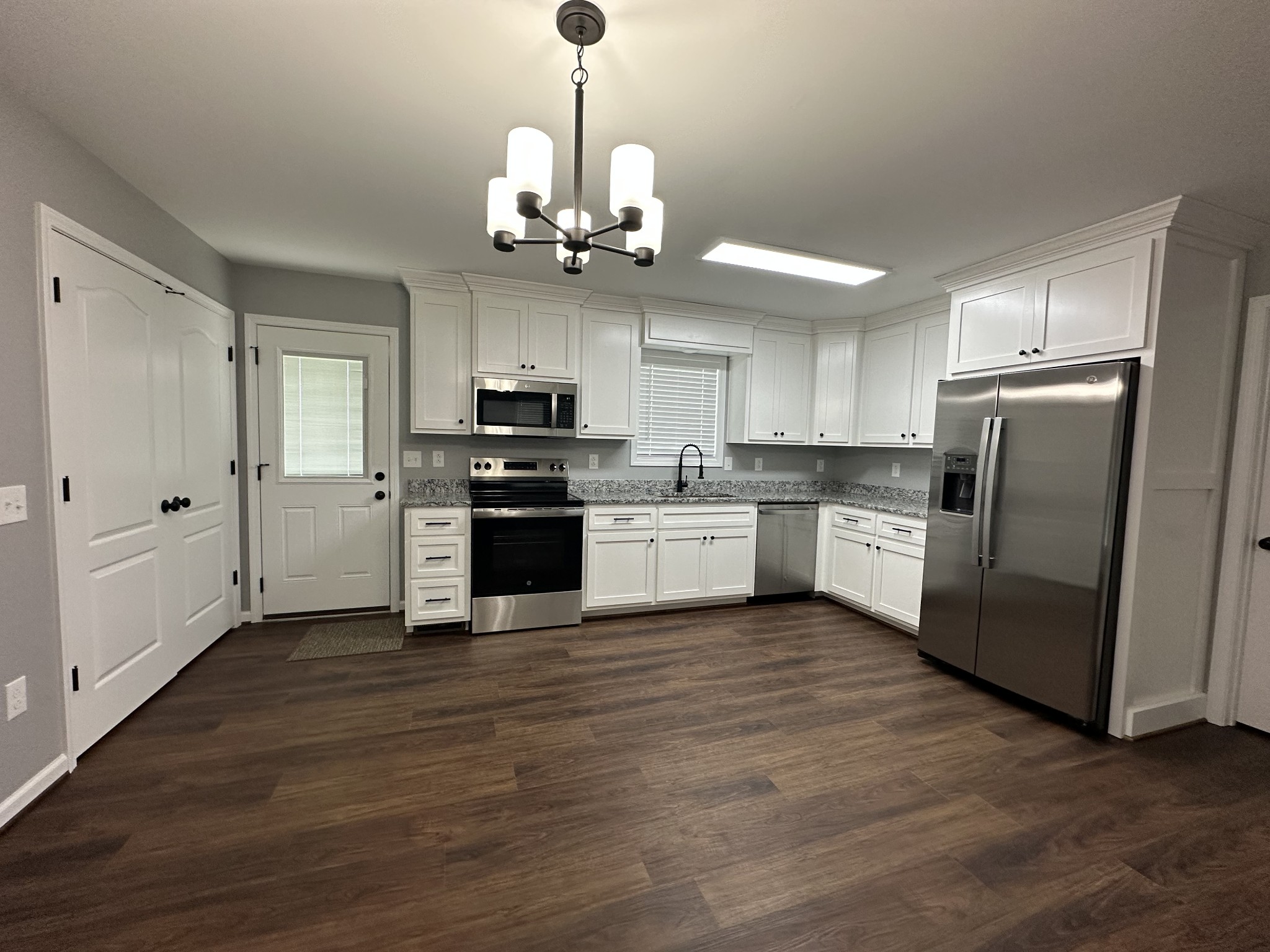 163 Rigling Road Loretto, TN 38469 - Photo 16 of 22 a kitchen with stainless steel appliances kitchen island a refrigerator and a stove top oven