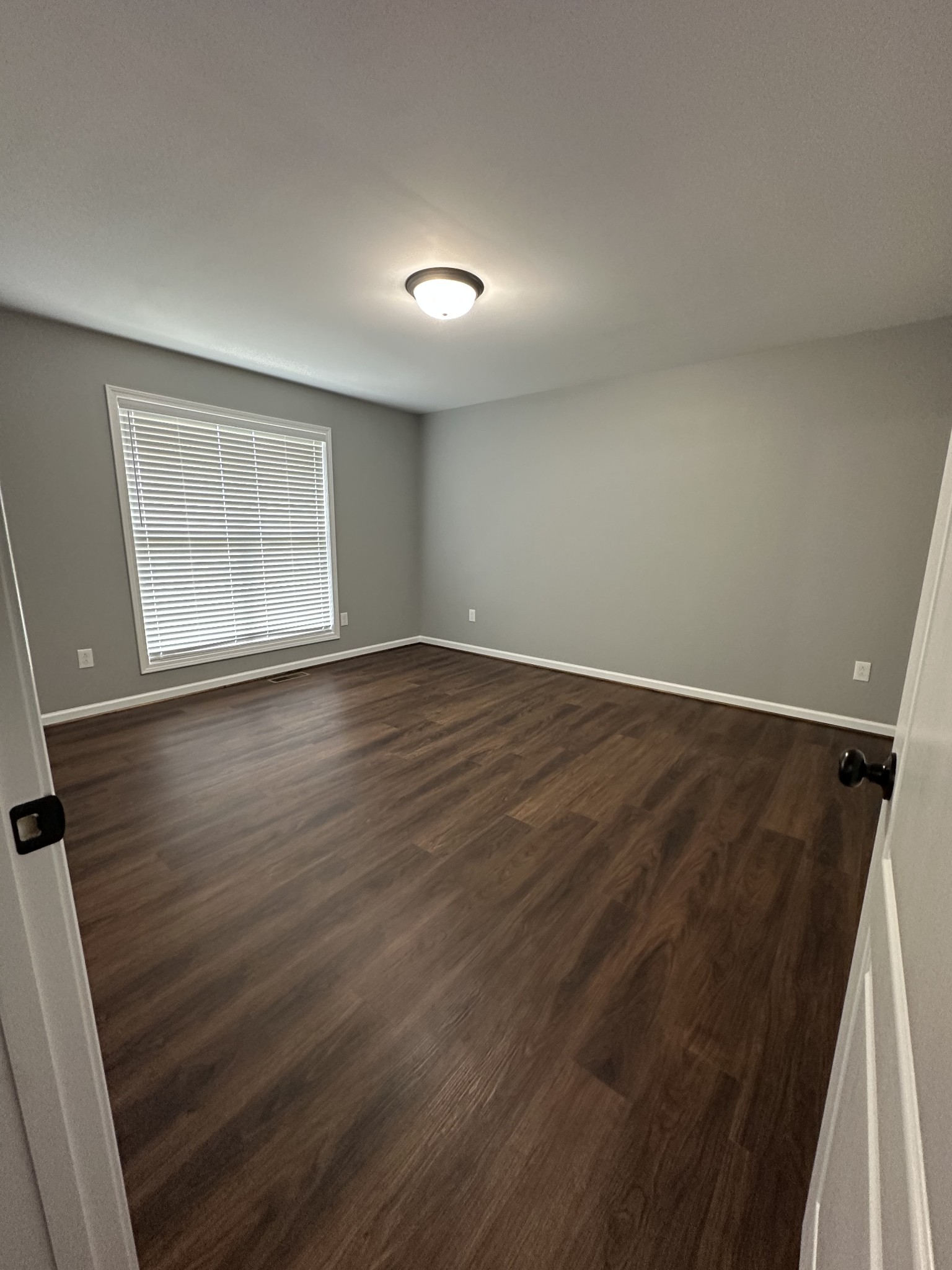 163 Rigling Road Loretto, TN 38469 - Photo 17 of 22 an empty room with wooden floor and windows