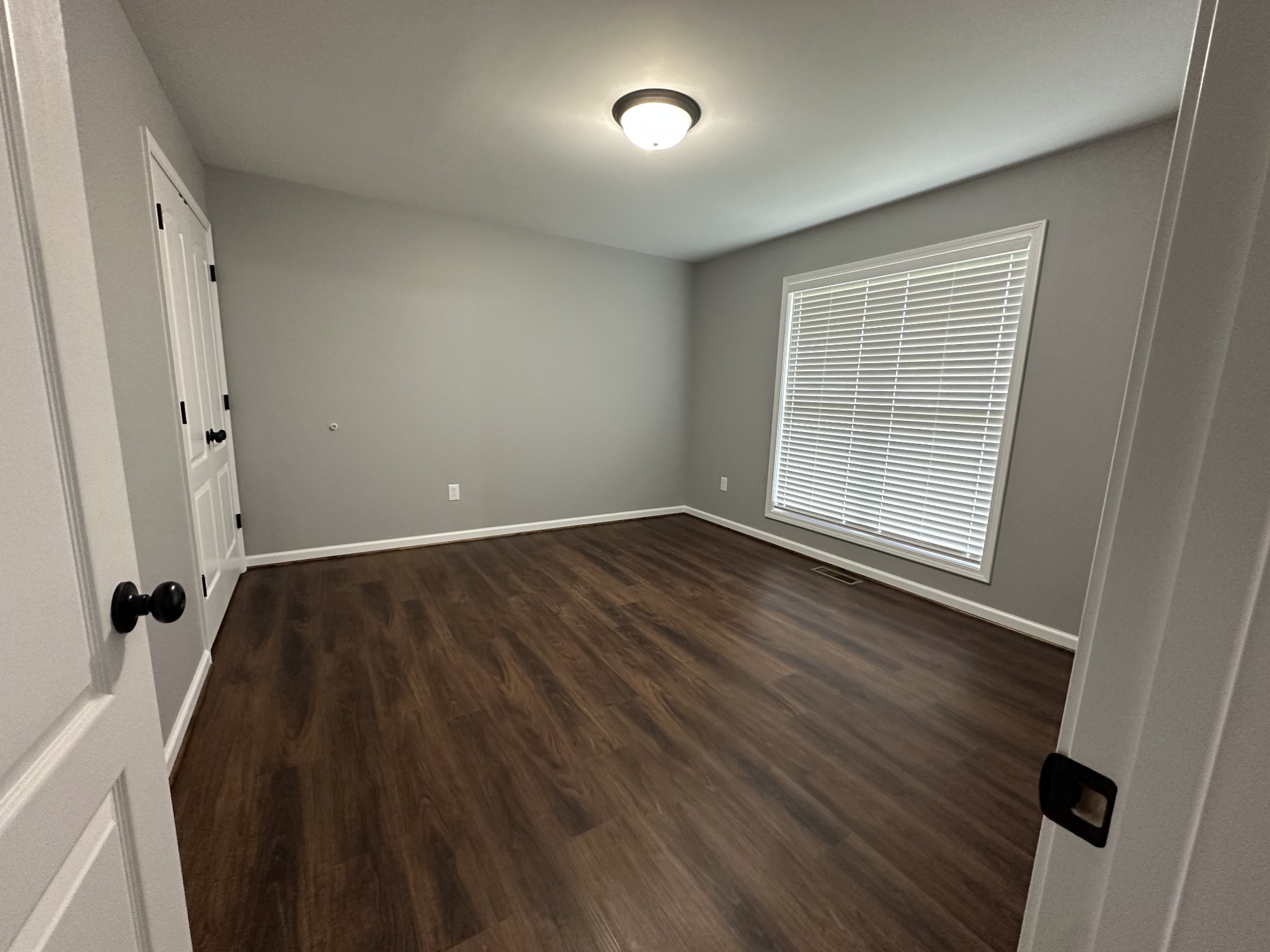 163 Rigling Road Loretto, TN 38469 - Photo 19 of 22 an empty room with wooden floor and windows