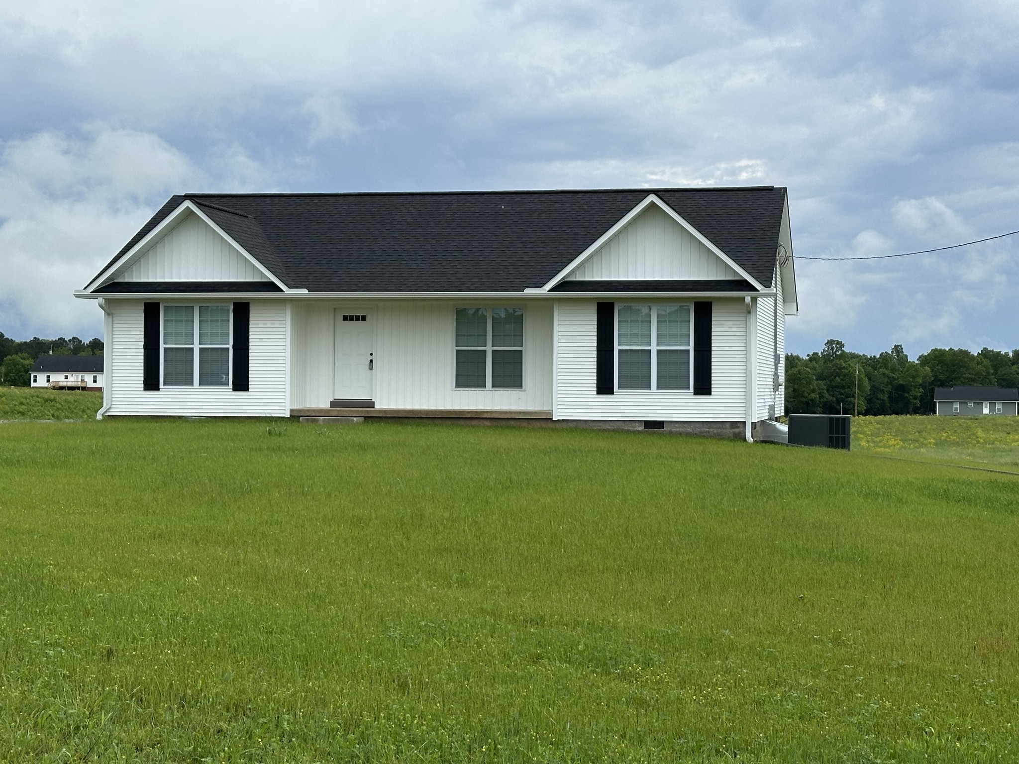 163 Rigling Road Loretto, TN 38469 - Photo 3 of 22 a front view of a house with a garden