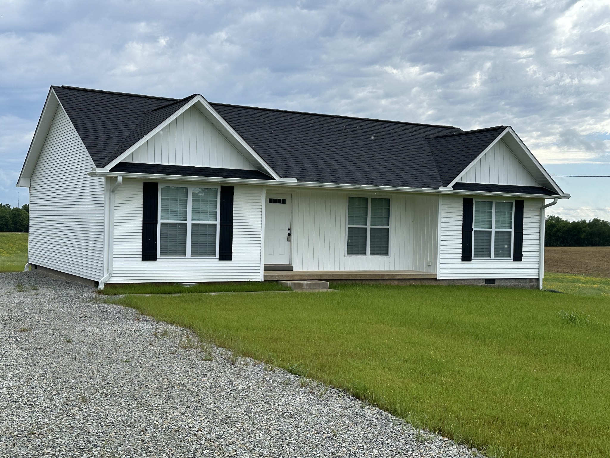163 Rigling Road Loretto, TN 38469 - Photo 5 of 22 a front view of a house with a garden