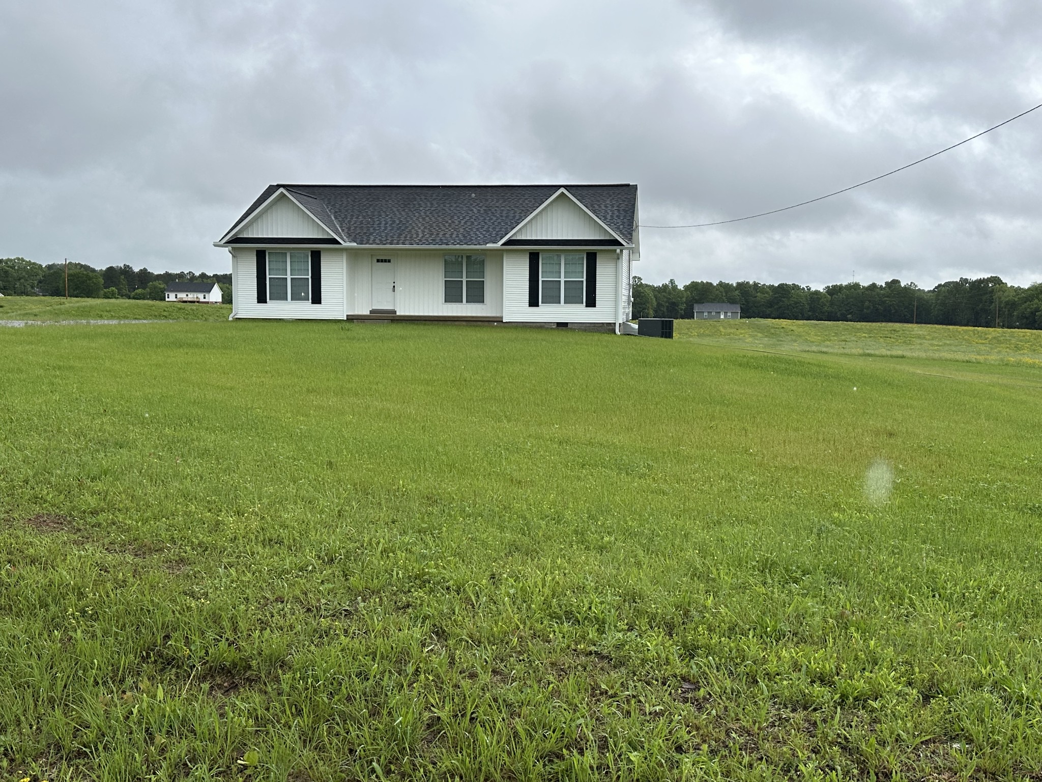 163 Rigling Road Loretto, TN 38469 - Photo 7 of 22 a front view of a house with garden