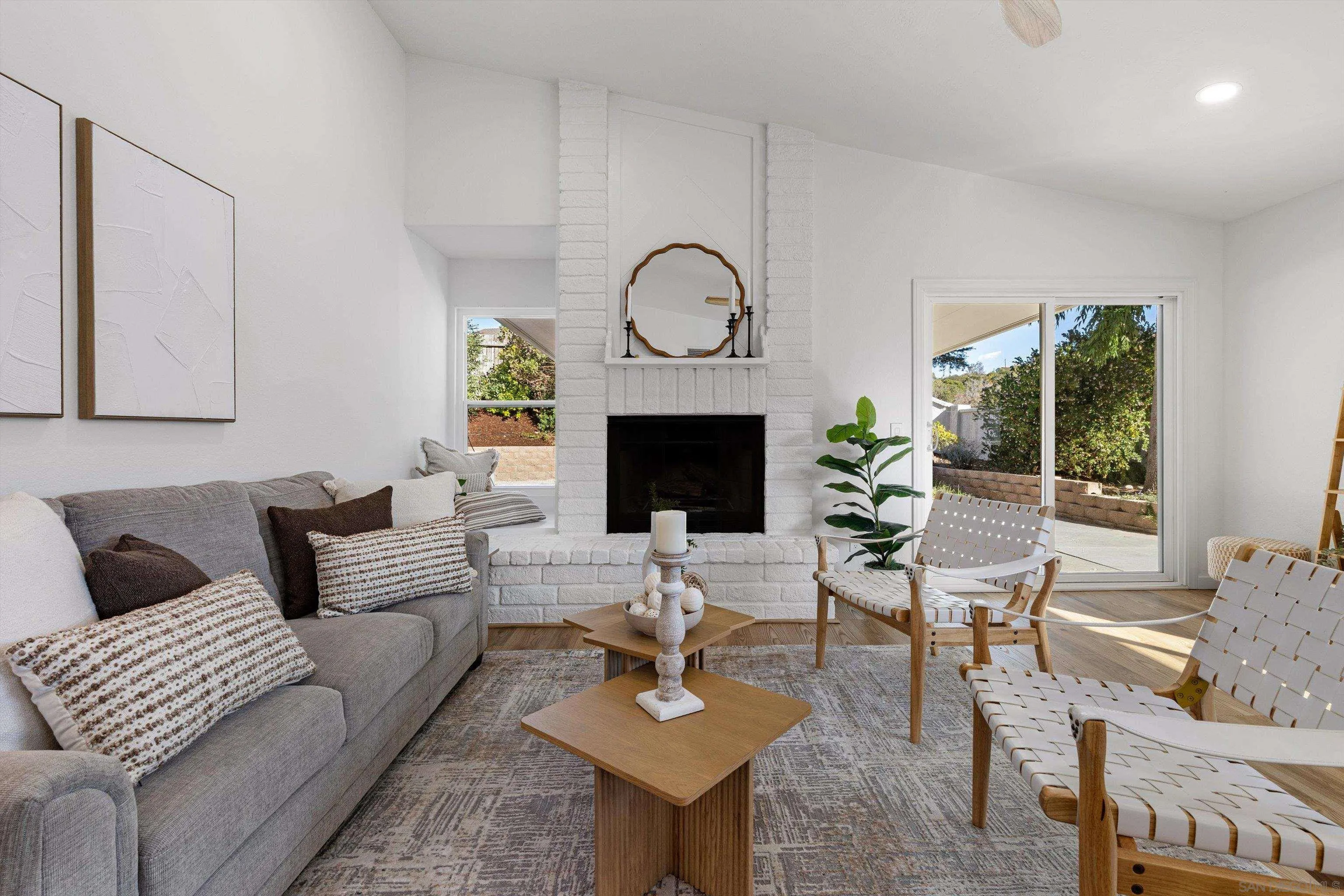 4640 Waverly Road Oceanside, CA 92056 - Photo 16 of 49 a living room with furniture a fireplace and a floor to ceiling window