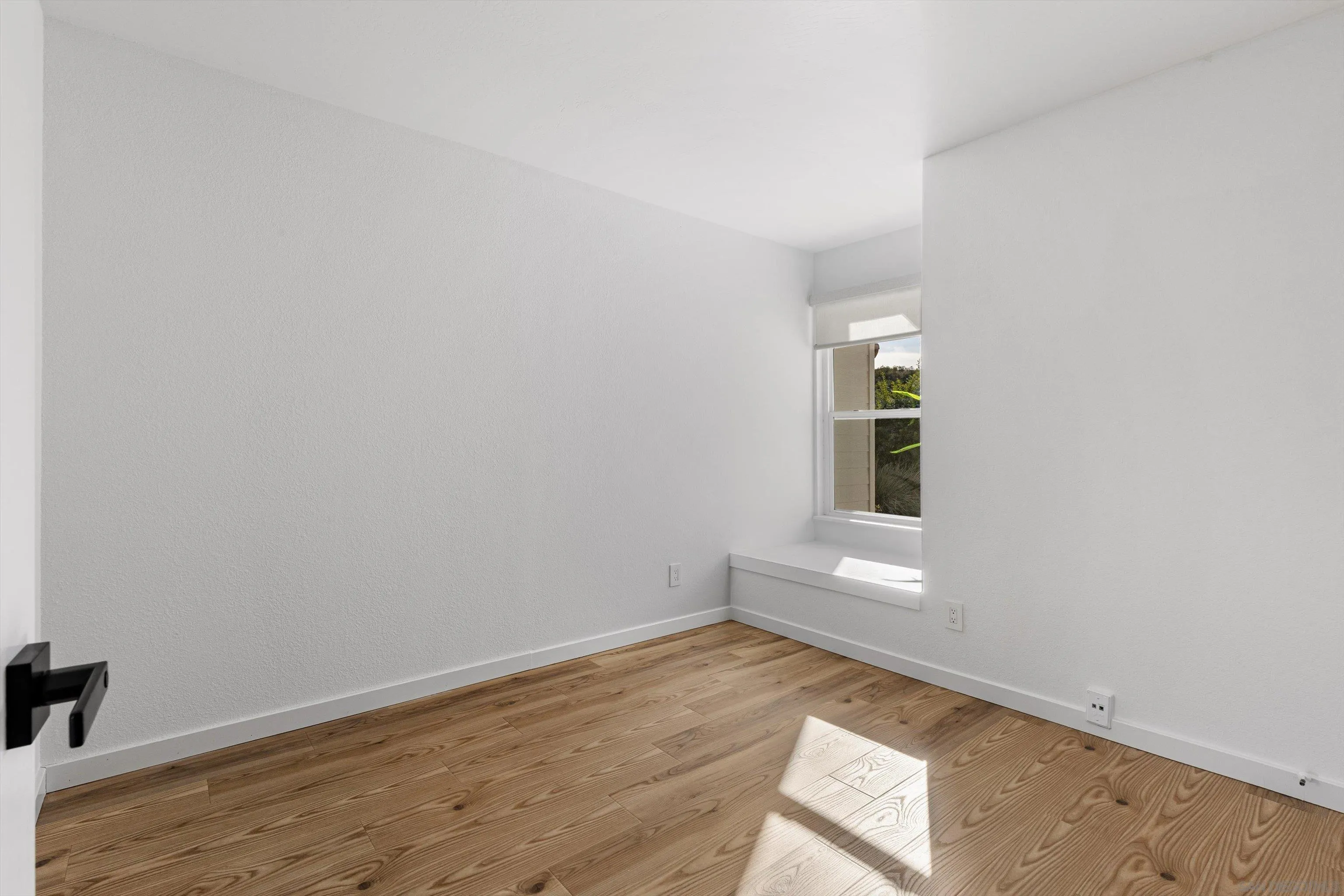 4640 Waverly Road Oceanside, CA 92056 - Photo 32 of 49 an empty room with wooden floor and windows