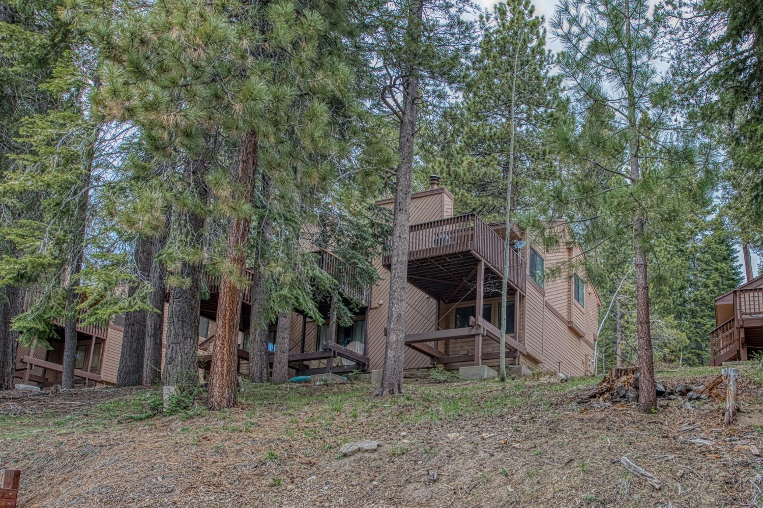 62721 Huntington Vista Road, Unit 119 Mono Hot Springs, CA 93642 - Photo 25 of 27 a view of a wooden house with a yard and large trees