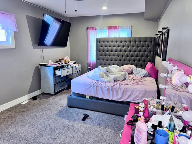 a bedroom with a bed and a window