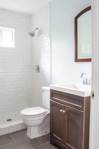 a bathroom with a toilet a sink and shower