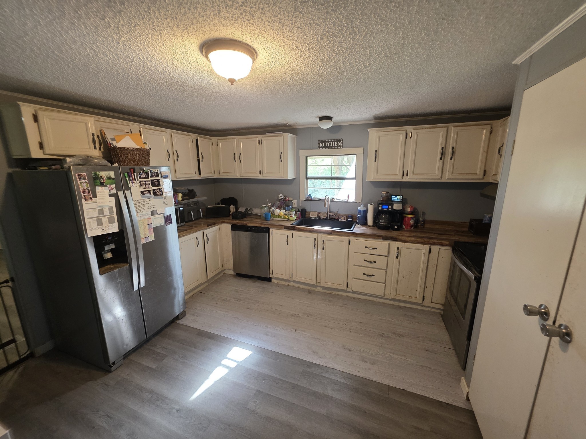 225 Opossum Hollow Road Watertown, TN 37184 - Photo 12 of 29 a kitchen with cabinets a refrigerator a sink a stove a microwave and cabinets