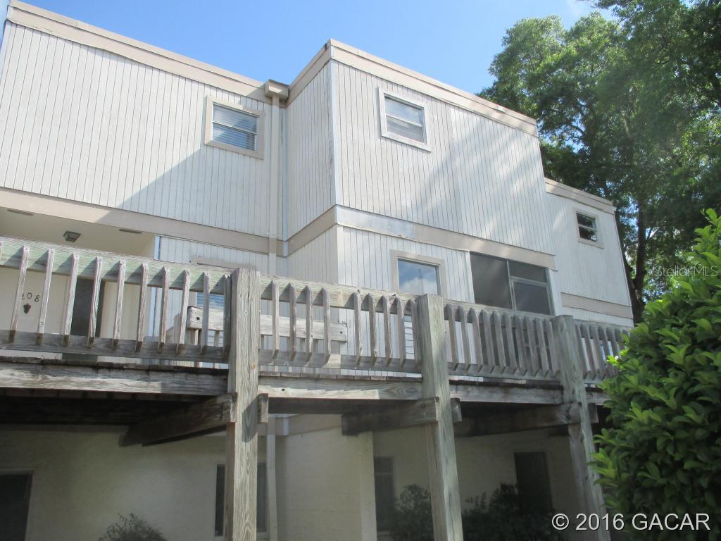 711 Southwest 75th Street, Unit 210 Gainesville, FL 32607 - Photo 1 of 1 a view of house with balcony and outdoor seating