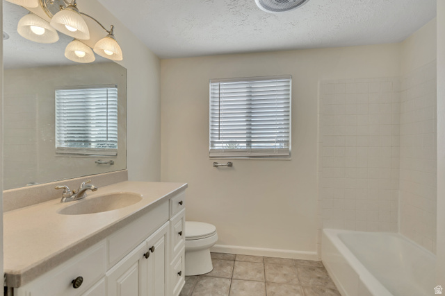 3166 Linden Street Bountiful, UT 84010 - Photo 8 of 25 Bathroom with vanity, light tile patterned floors, healthy amount of natural light, and a textured ceiling