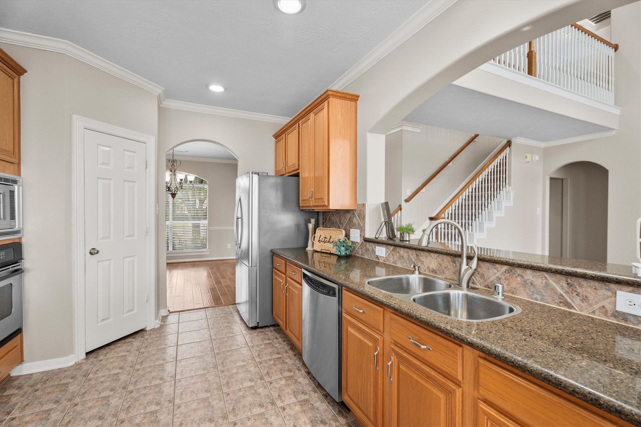 6323 Stone Trail Lane Spring, TX 77379 - Photo 10 of 43 a kitchen with stainless steel appliances granite countertop a sink and a refrigerator
