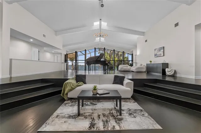 a living room with furniture and kitchen view