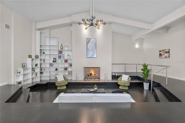 a living room with furniture and a floor to ceiling window
