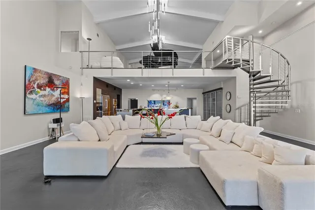 a kitchen with refrigerator and chairs