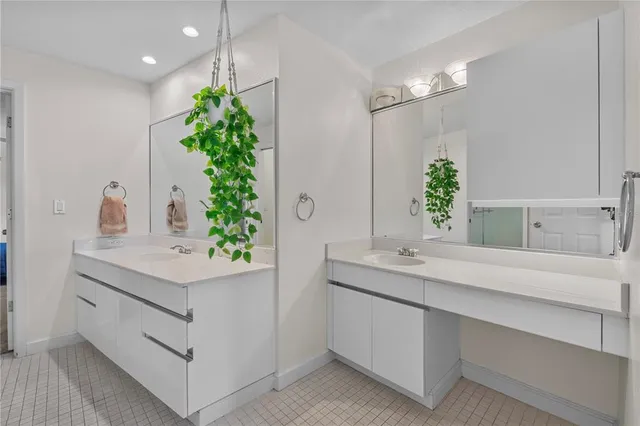 a table with chairs and a vase of flowers sitting on a table