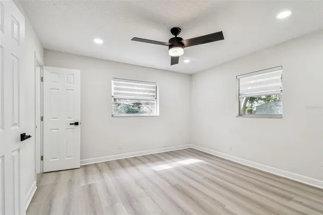 a view of a hallway with wooden floor and entryway