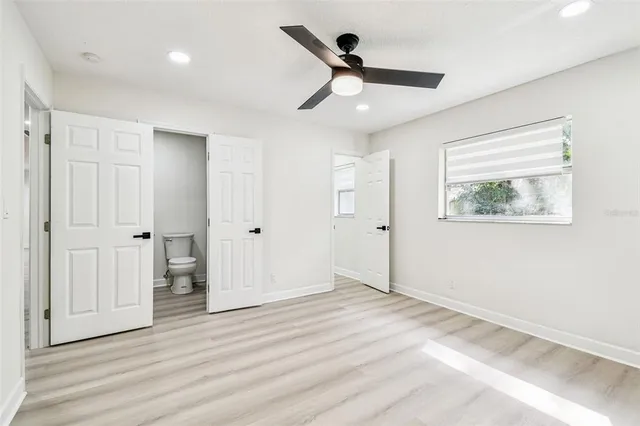 a view of a hallway with wooden floor and closet