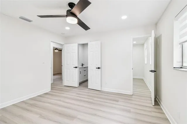 a view of a hallway with wooden floor and closet area