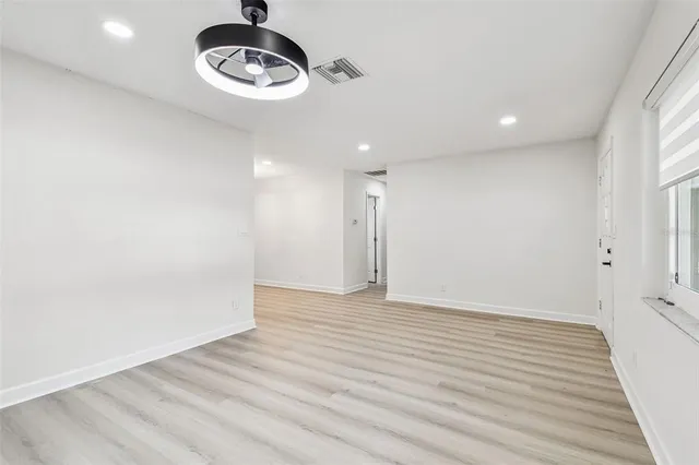 an aerial view of residential house with outdoor space and trees all around