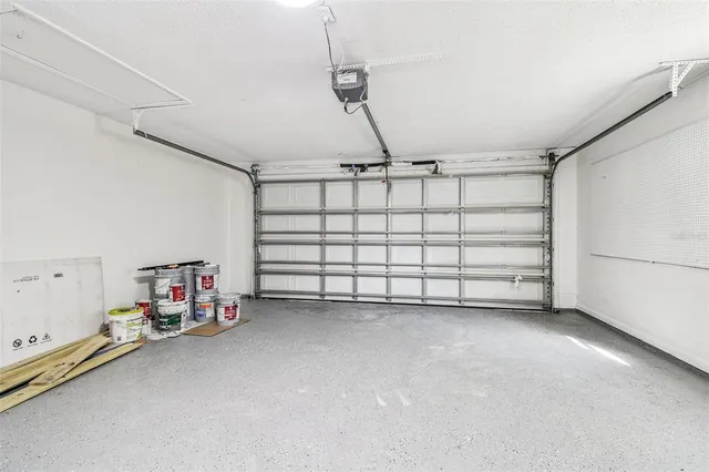 an aerial view of residential house with outdoor space and trees all around