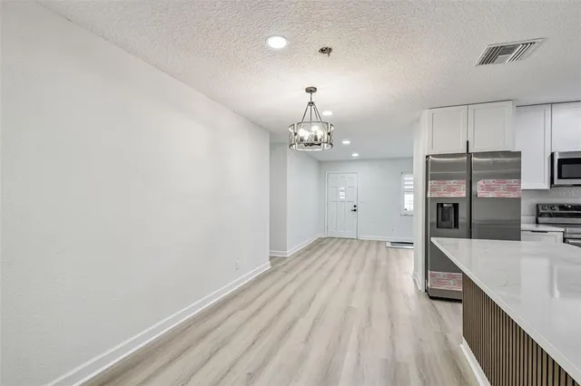 a kitchen with a sink cabinets and wooden floor
