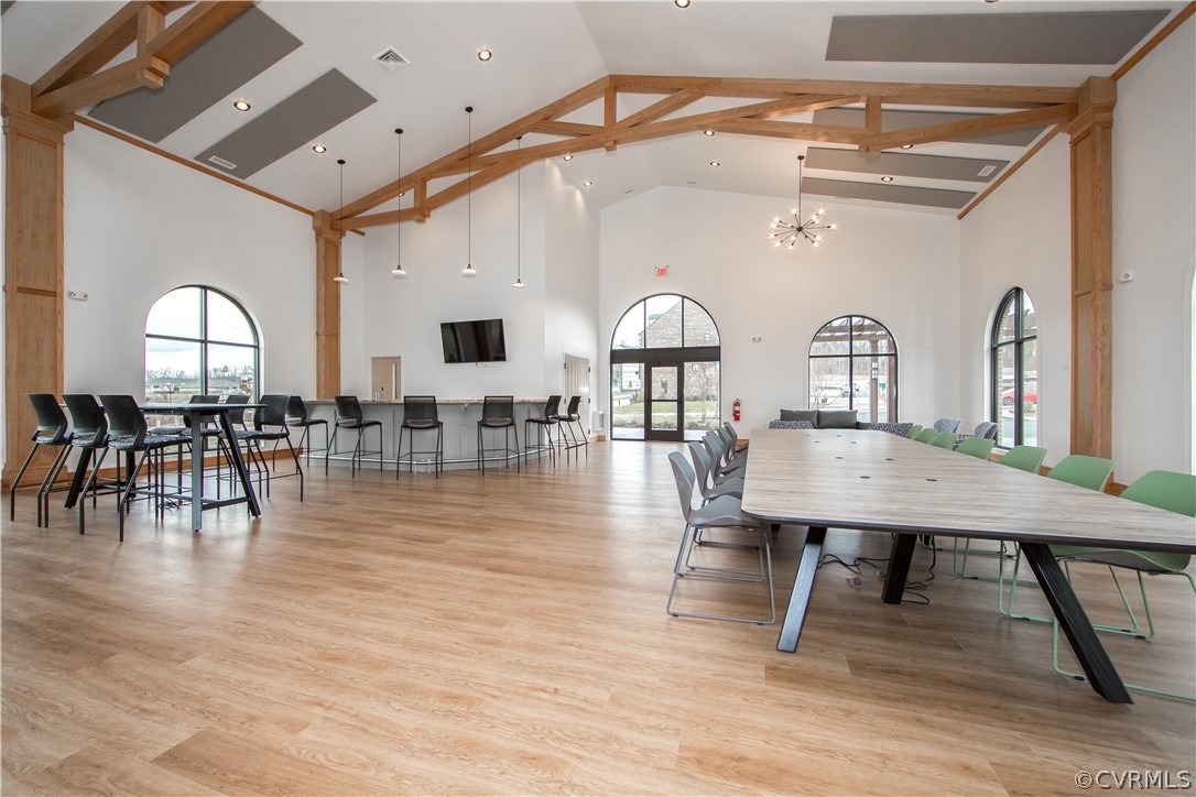 14112 Millpointe Road, Unit 4C Midlothian, VA 23114 - Photo 15 of 18 a dining room with wooden floor a chandelier a wooden table and chairs
