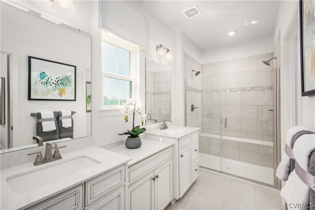 14112 Millpointe Road, Unit 4C Midlothian, VA 23114 - Photo 9 of 18 a bathroom with double vanity sinks a large mirror and a shower