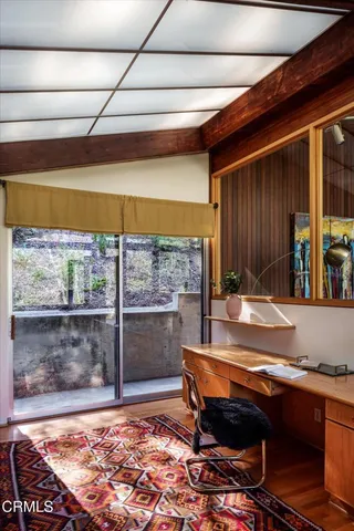 a view of workspace with furniture and window