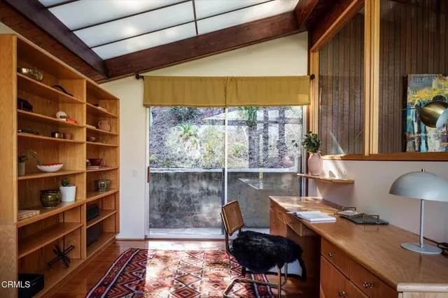 a dining room with furniture and potted plants
