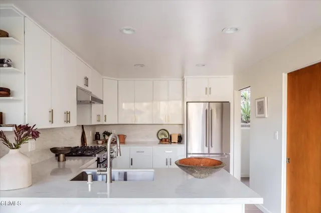 a view of a hallway to a livingroom with furniture and front door