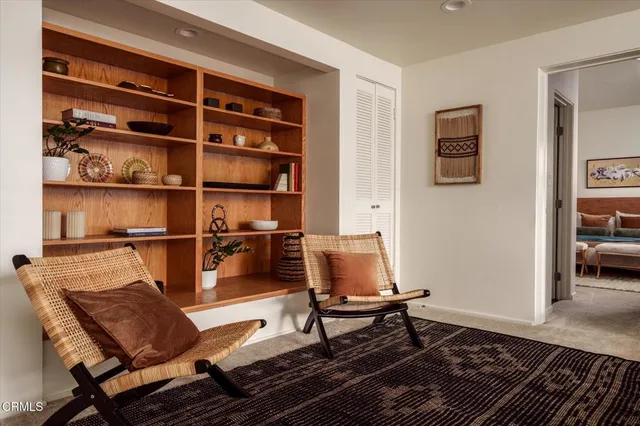 a view of a chairs and table in the balcony