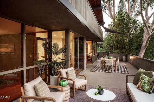 a backyard of a house with yard and outdoor seating
