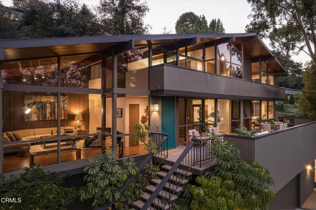 a living room with furniture and a painting on the wall