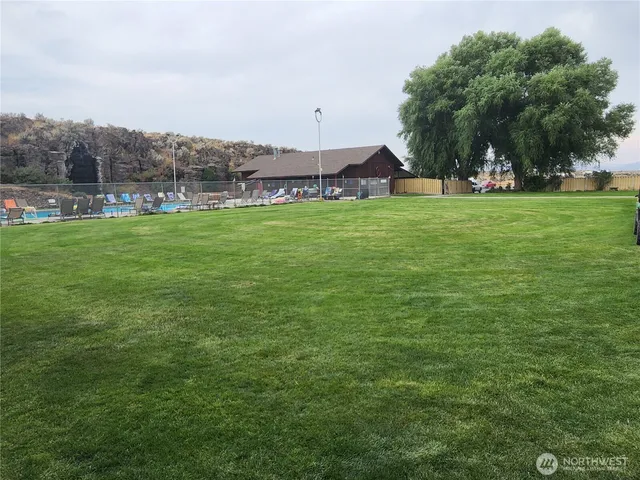 a view of a wooden deck and a yard