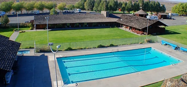 a view of yard with swimming pool and sitting area
