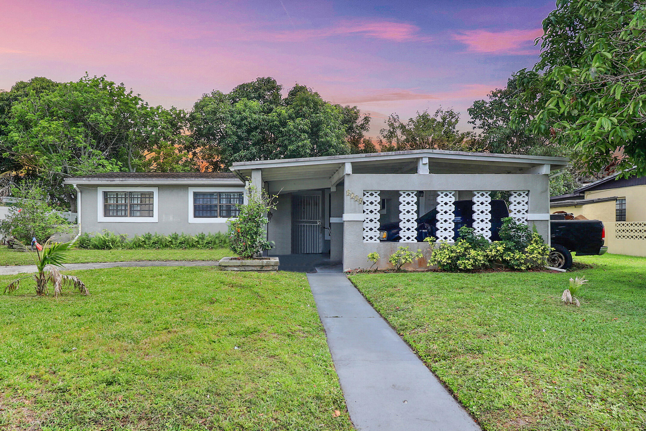 4710 Northwest 11th Place Lauderhill, FL 33313 - Photo 1 of 12 a front view of house with yard and green space