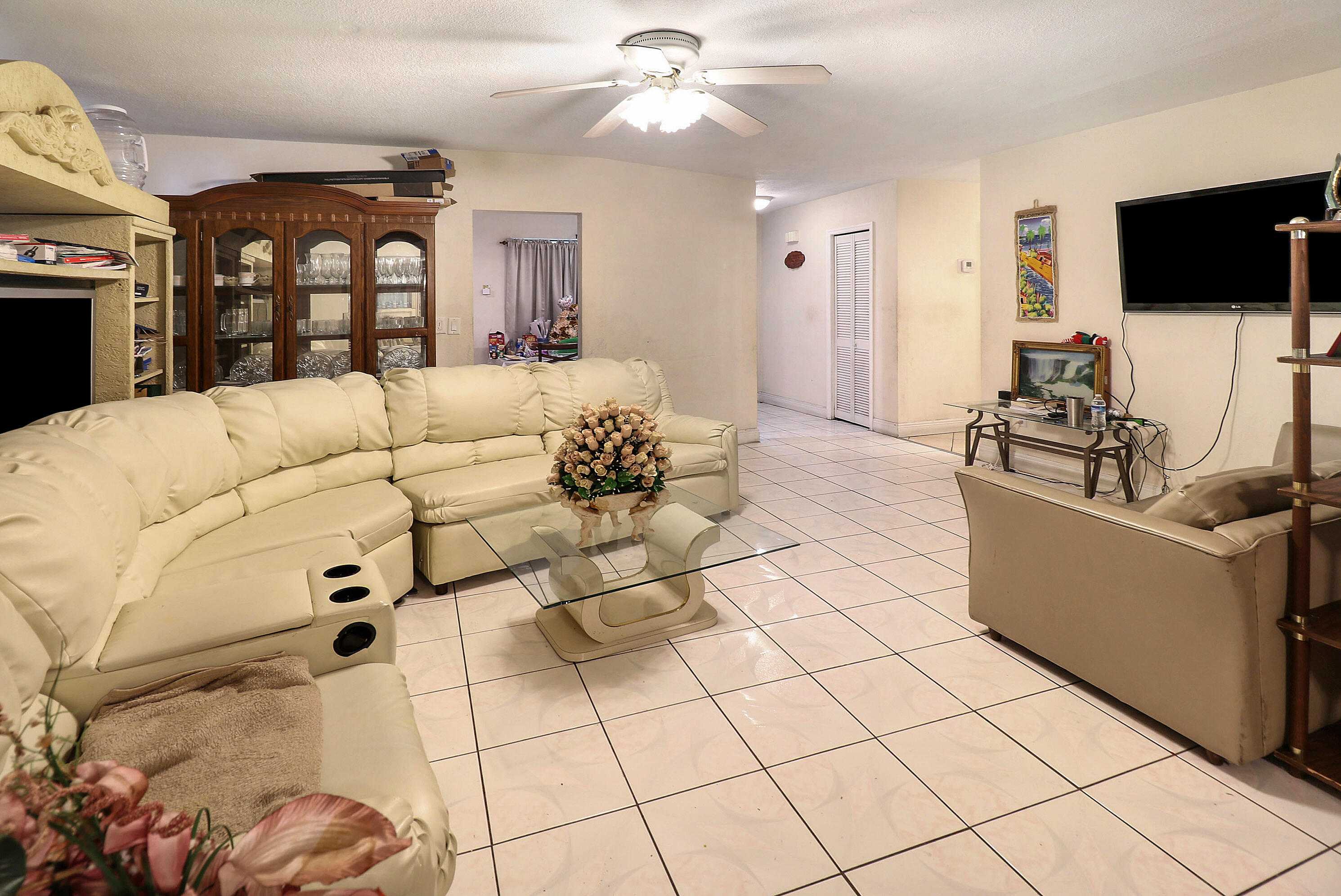 4710 Northwest 11th Place Lauderhill, FL 33313 - Photo 2 of 12 a living room with furniture and a flat screen tv