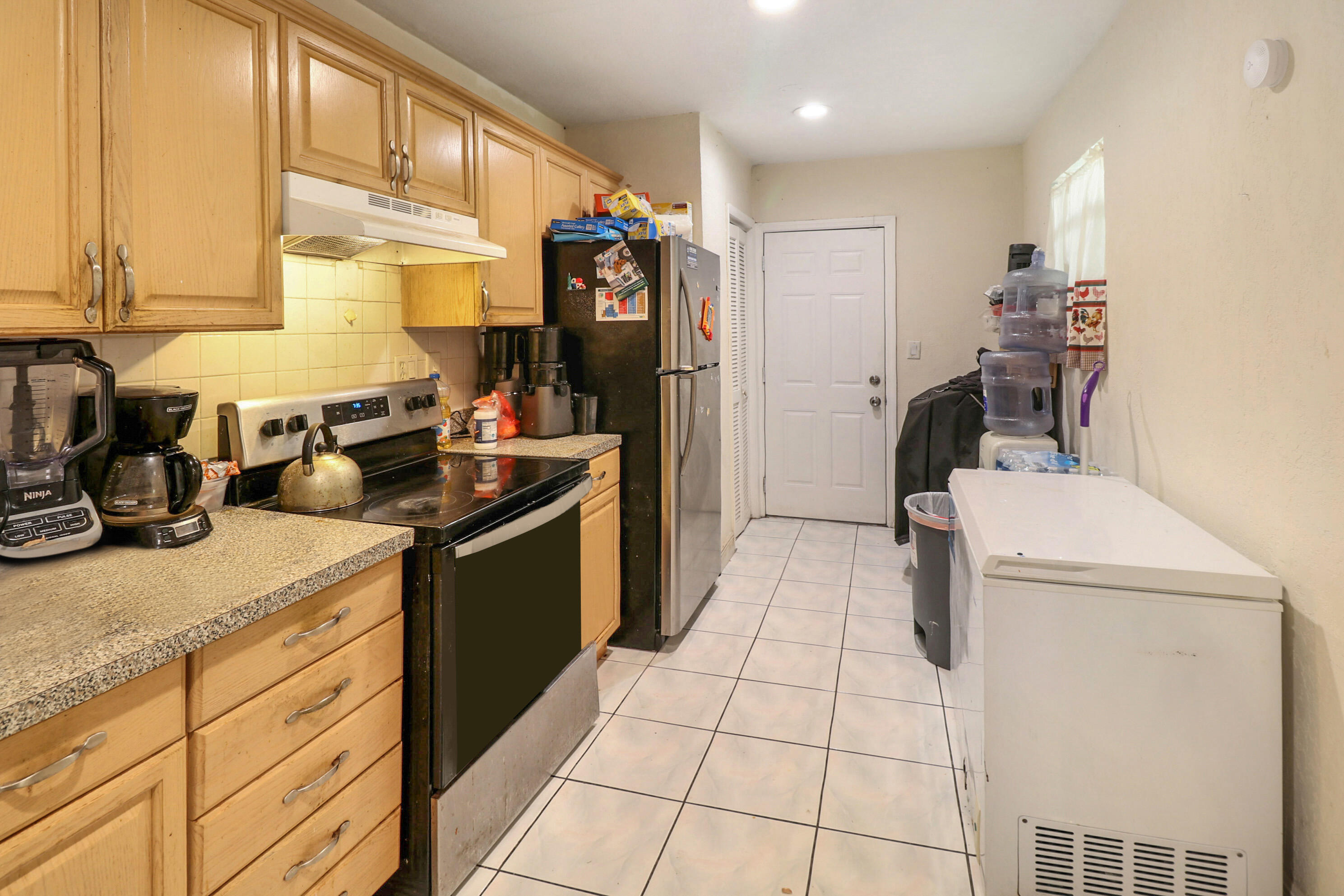 4710 Northwest 11th Place Lauderhill, FL 33313 - Photo 5 of 12 a kitchen with a sink appliances and cabinets