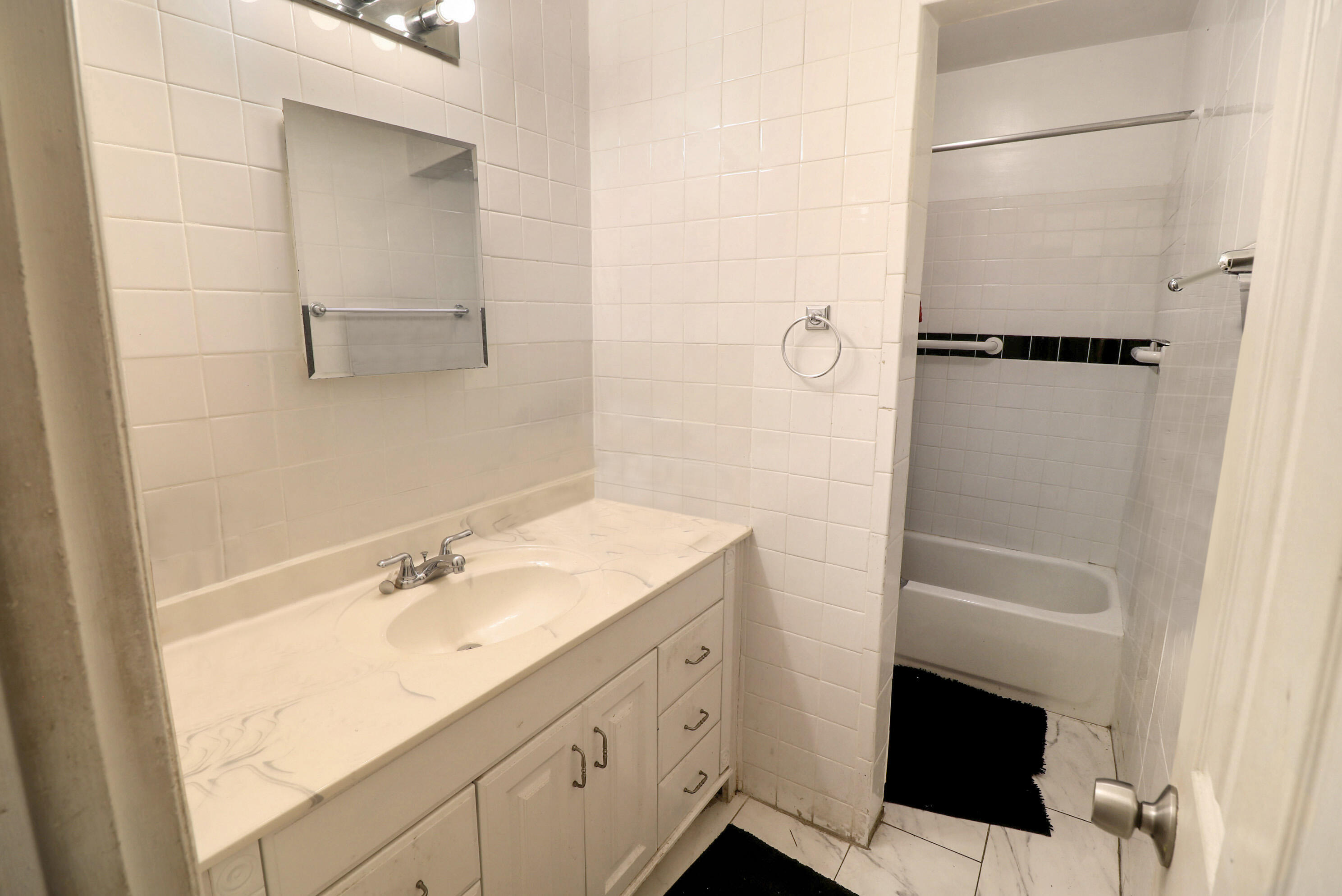 4710 Northwest 11th Place Lauderhill, FL 33313 - Photo 8 of 12 a bathroom with a sink a toilet and shower