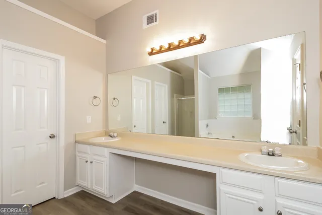 a bathroom with a double vanity sink and mirror
