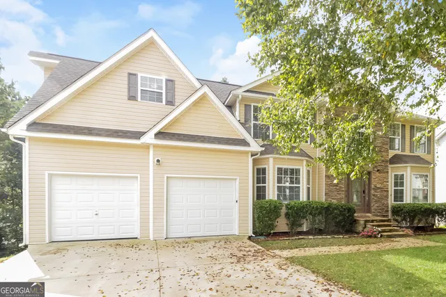 a front view of a house with a yard