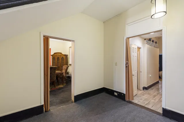 a view of a dining room with furniture and a chandelier