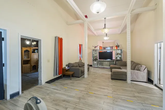 a view of a livingroom with workspace and a window
