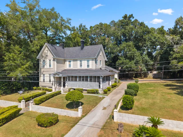 a view of a house with swimming pool and sitting area