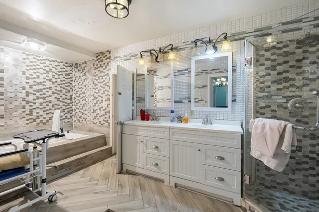 a living room with furniture a fireplace and chandelier