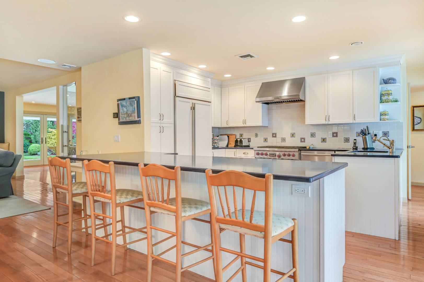60 South Road Westhampton Beach, NY 11978 - Photo 11 of 45 a kitchen with stainless steel appliances granite countertop a stove a sink a dining table and chairs
