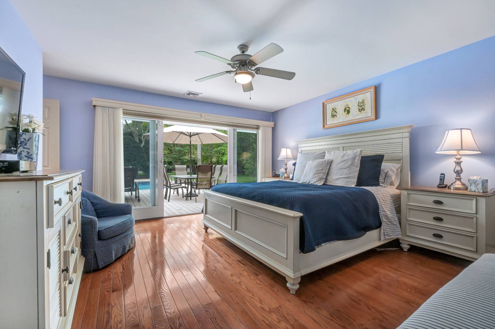60 South Road Westhampton Beach, NY 11978 - Photo 12 of 45 a spacious bedroom with a large bed and a chandelier