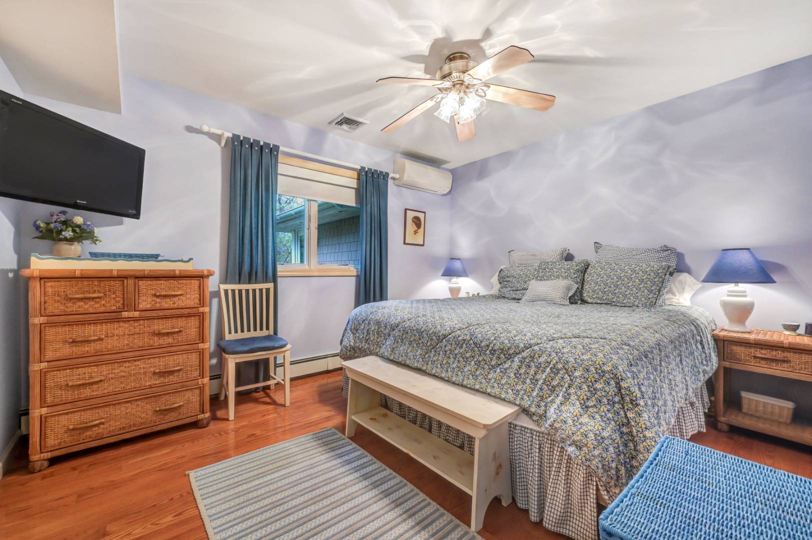 60 South Road Westhampton Beach, NY 11978 - Photo 17 of 45 a bedroom with a bed and a flat screen tv