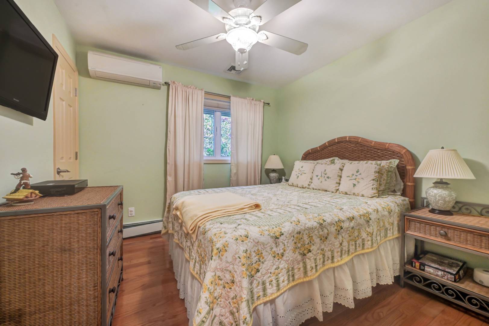 60 South Road Westhampton Beach, NY 11978 - Photo 19 of 45 a bedroom with a bed and a flat tv screen on dresser