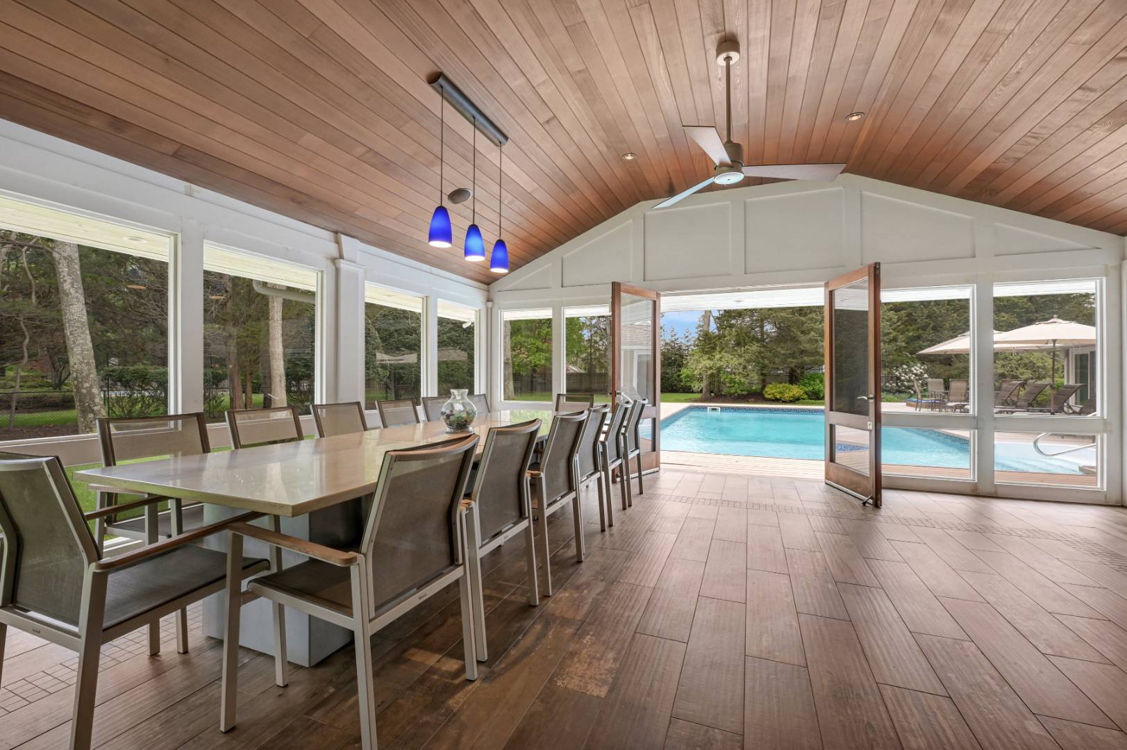 60 South Road Westhampton Beach, NY 11978 - Photo 25 of 45 a dining room with wooden floor and outdoor seating